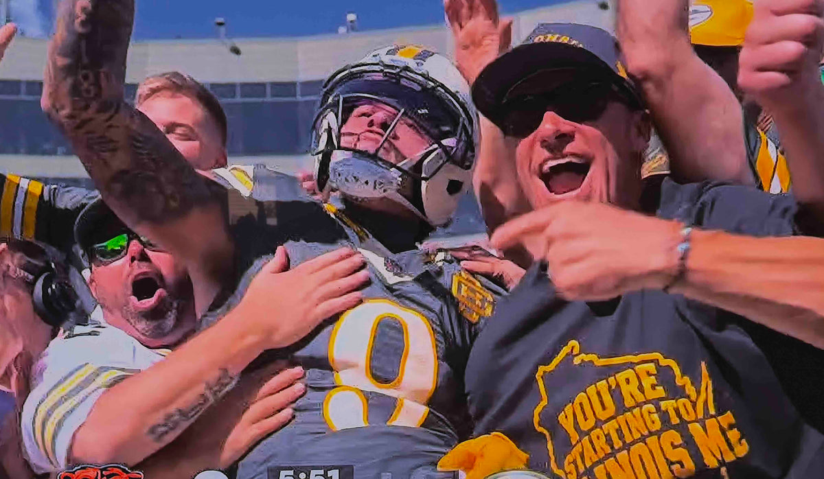 Christian Watson Lambeau Leap touchdown catch, Packers vs Bears, Lambeau Field, October 2026 — You're Starting to Illinois Me shirt in the crowd
